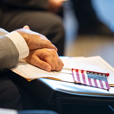 Hands and flag - naturalization ceremony